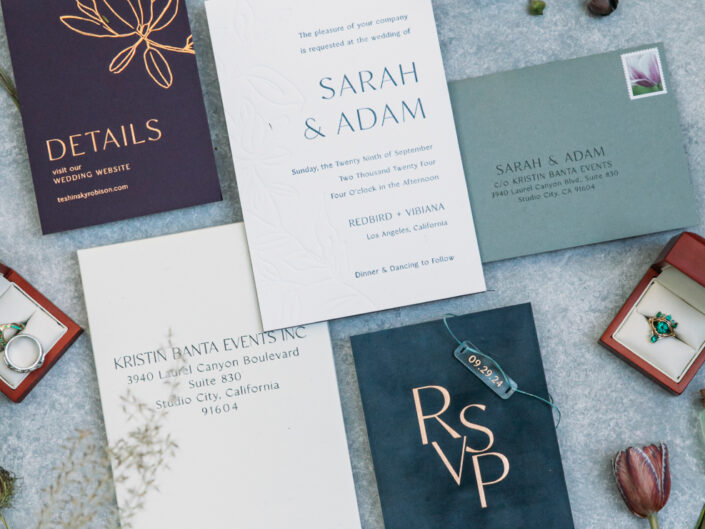 Invitation suite with muted dark purple, velvet dark blue, turquoise, and white/cream accents, creating an elegant and sophisticated design