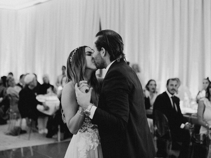 Bride and groom sharing their first dance together as a married couple at their wedding reception.