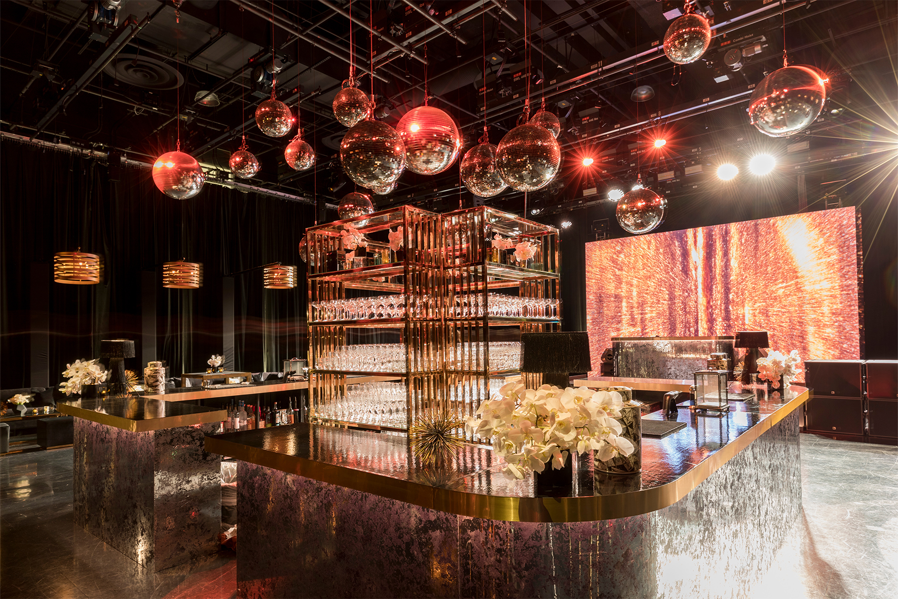 Elegant reception with candlelit tables, chandeliers and botanical projections